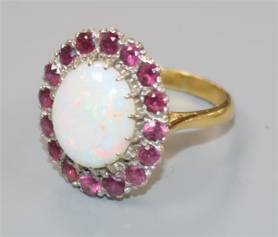 An 18ct gold, white opal and ruby set oval cluster dress ring, size L.